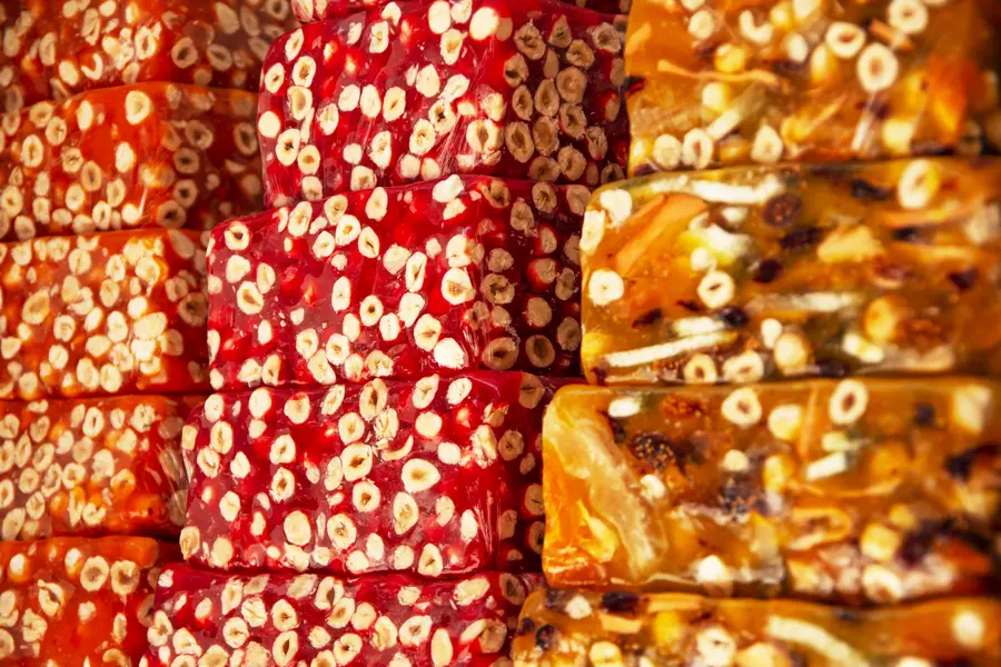 Vivid rows of colourful artisan confections at a traditional market stall